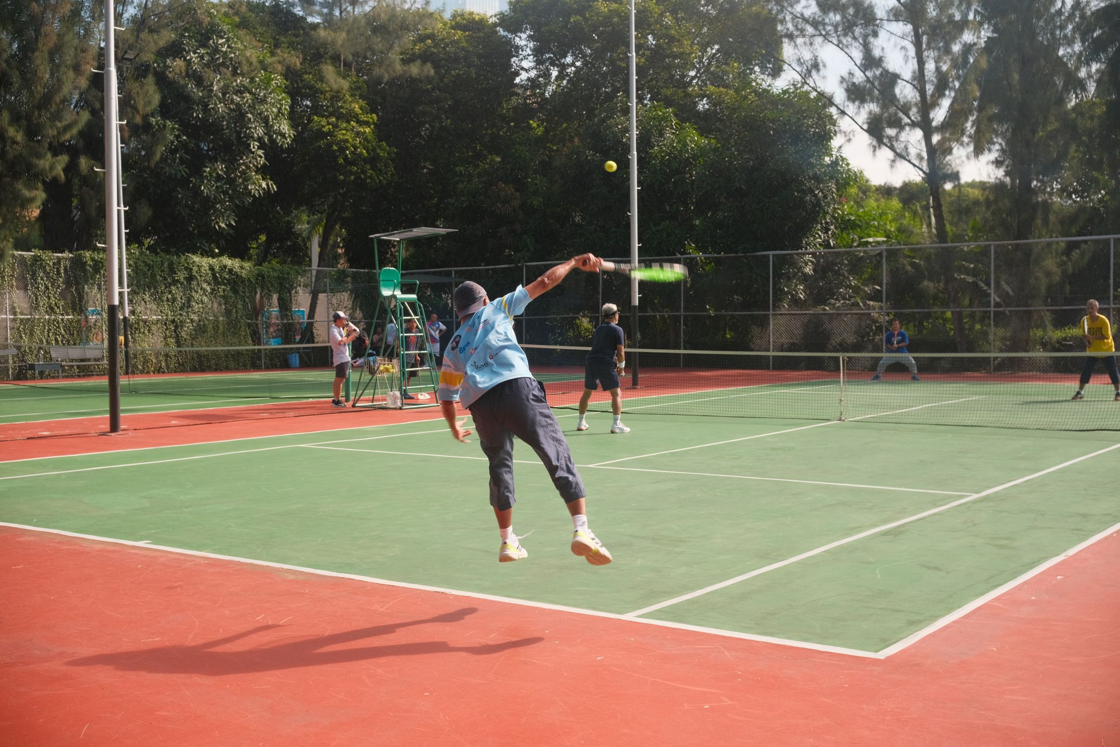 Tennis players competing in an energetic outdoor match