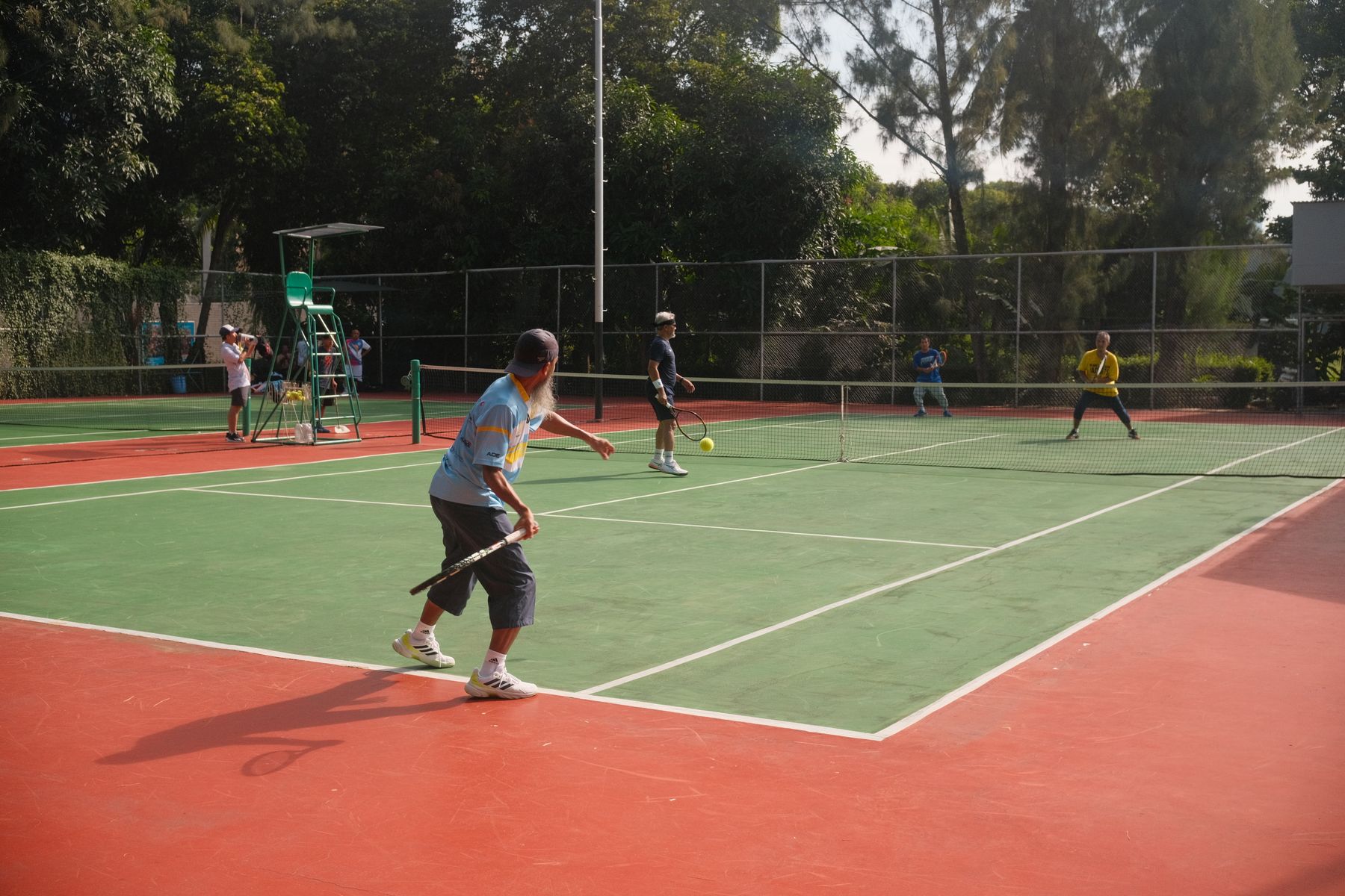 Players enjoying a tennis match on an outdoor court